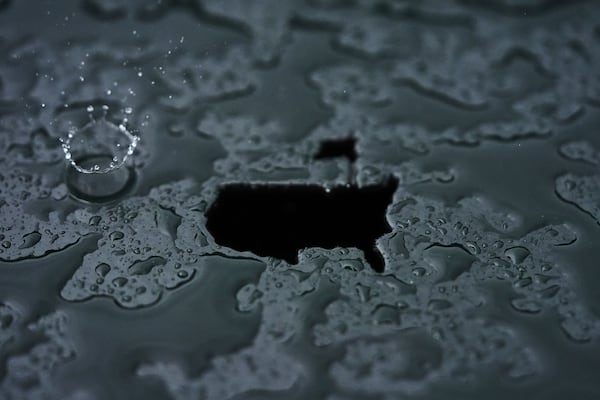 A rain droplet falls on a Masters logo cut out during a practice round at the Masters golf tournament, Monday, April 7, 2025, in Augusta, Ga. (AP Photo/Matt Slocum)