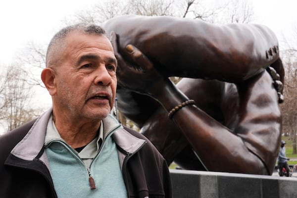 Wayne Lucas, who sixty years ago participated at the Freedom Rally on Boston Common, is interviewed at the "The Embrace" sculpture on the common, Tuesday, April 15, 2025, in Boston. (AP Photo/Charles Krupa)
