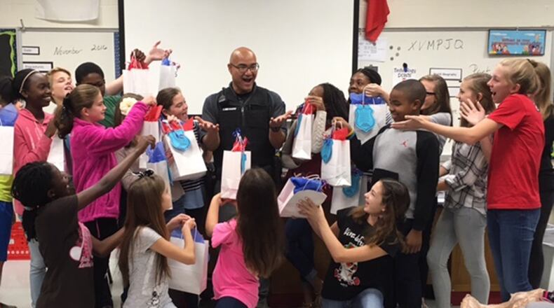 Whitewater Middle School resource officer Lawrence Vazquez shows his excitement for the goodie bags the school’s student council gave to all county school resource officers.