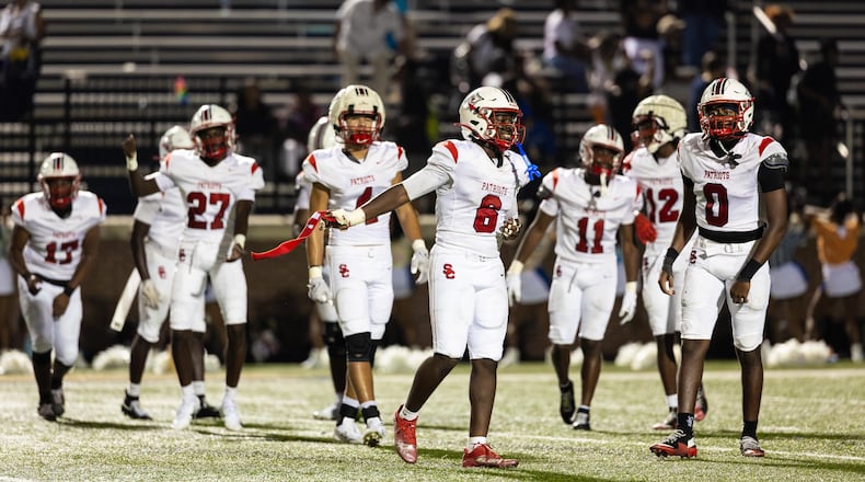 Sandy Creek linebacker Elijah Ware (front) and teammates celebrate their victory over Douglas County on Friday, Aug. 28, 2026, at Douglas County High School. (Oscar Guevara Saenz for the AJC)