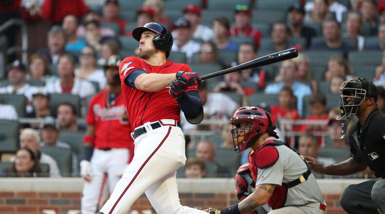 Braves left fielder Adam Duvall swings for the fence in the seventh-inning, his two-run home run breaking open Game Two of the National League Division Series against St. Louis. (JASON GETZ/SPECIAL TO THE AJC)