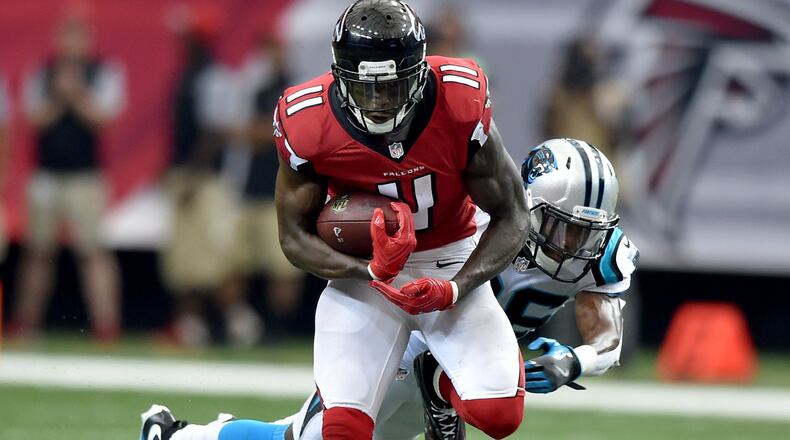 October 2, 2016 Atlanta: Atlanta Falcons wide receiver Julio Jones hauls in a Matt Ryan pass in front of Carolina Panthers cornerback Daryl Worley in the Georgia Dome Sunday October 2, 2016. Jones set a franchise record with 12 receptions and 300 yards and 1 touchdown. The performance was the 6th-highest receiving yardage game in NFL history. BRANT SANDERLIN/BSANDERLIN@AJC.COM