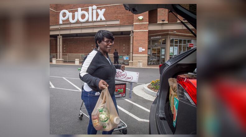 An Instacart shopper loads her car after picking up groceries from Publix for her clients Sunday, March 29, 2020. She said needs the work and was not going to join a possible strike. (Photo: STEVE SCHAEFER / SPECIAL TO THE AJC)
