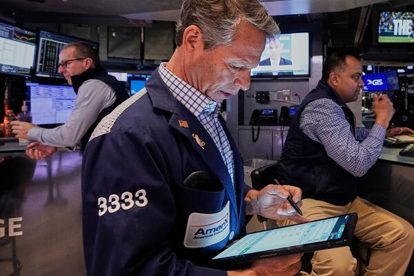 Trader Robert Charmak, center, works on the floor of the New York Stock Exchange, Friday, April 25, 2025. (AP Photo/Richard Drew)