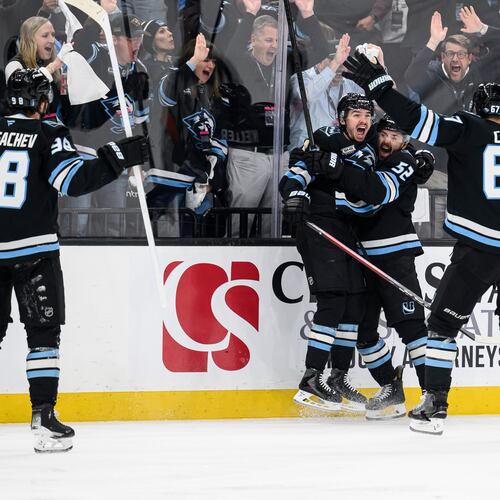 Utah Mammoth right wing Clayton Keller, center left, reacts to scoring a goal with teammates Utah Mammoth defenseman MacKenzie Weegar, center right, Utah Mammoth left wing Lawson Crouse, right, and Utah Mammoth defenseman Mikhail Sergachev, left, during the third period of Game 4 of a first-round NHL hockey Stanley Cup playoff series, Monday, April 27, 2026, in Salt Lake City. (AP Photo/Tyler Tate)
