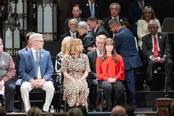 A woman is escorted away after getting onto the stage to speak to U.S. Senator James Lankford during the 30th anniversary memorial service for the victims of the 1995 Oklahoma City bombing, in Oklahoma City, Saturday, April 19, 2025. (AP Photo/Alonzo Adams)