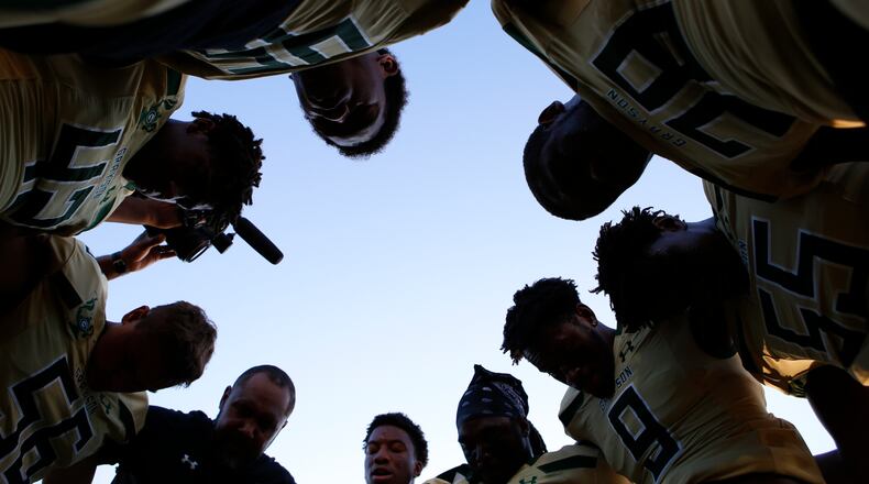 Grayson players gather in a circle for prayer prior to a game. (Casey Sykes for The Atlanta Journal-Constitution)
