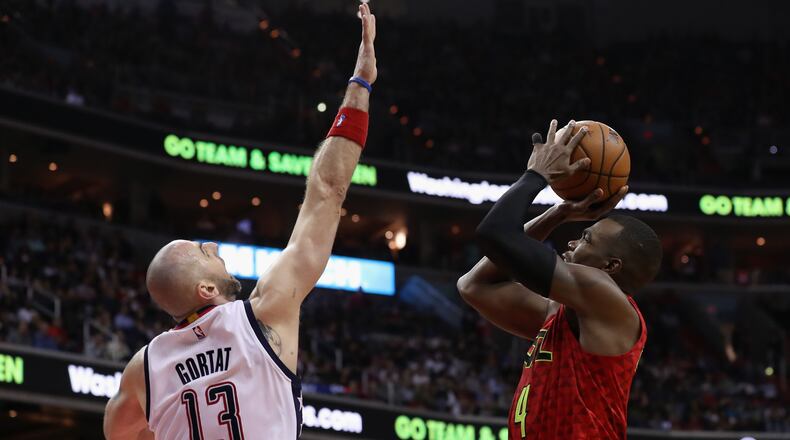 Paul Millsap of the Atlanta Hawks puts up a shot in front of Marcin Gortat of the Washington Wizards in the second half in Game 5 of the Eastern Conference Quarterfinals at Verizon Center on April 26, 2017 in Washington, DC. (Photo by Rob Carr/Getty Images)