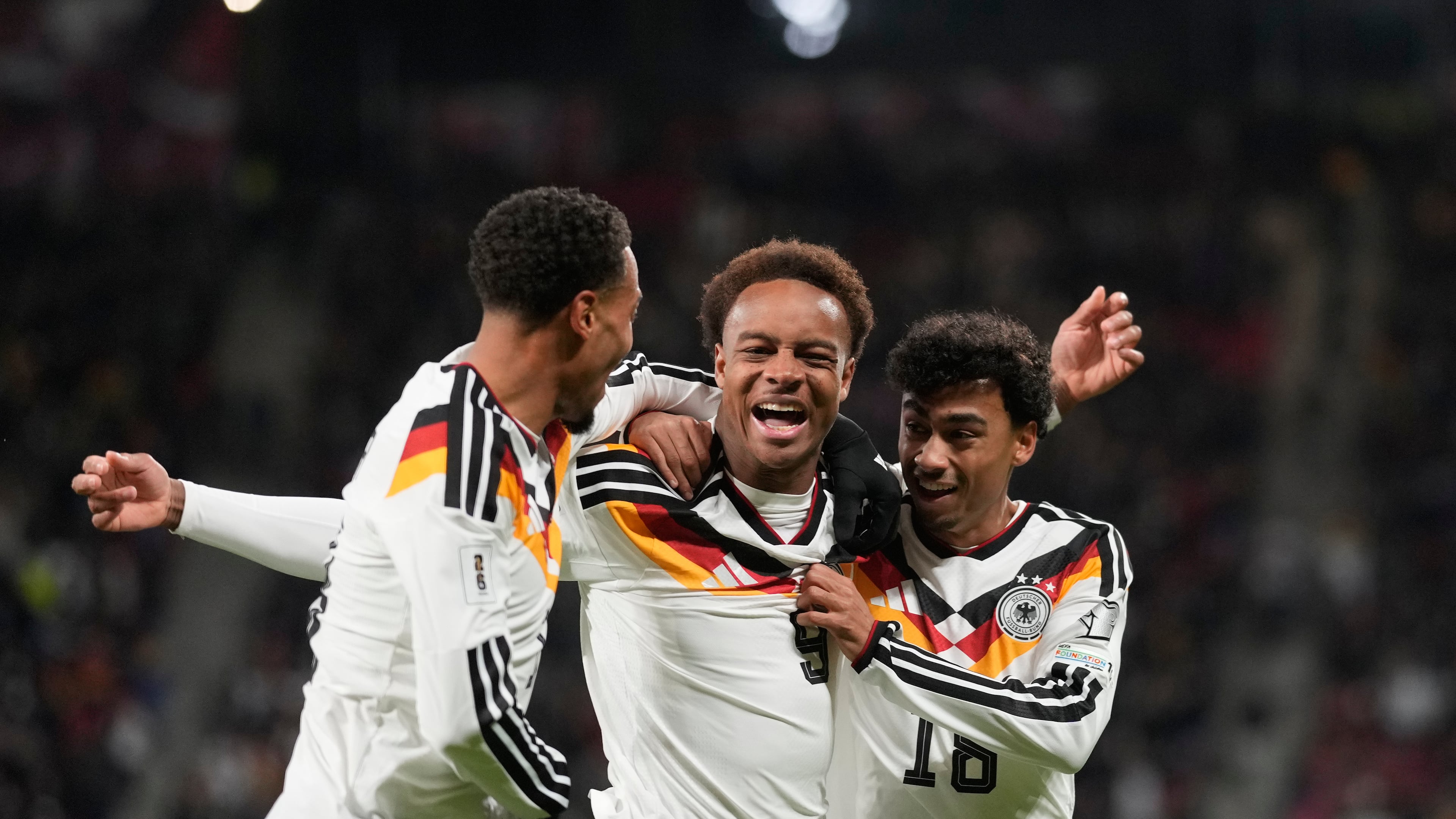 Germany's Assan Ouedraogo, center, celebrates after scoring during a group A World Cup qualifiying soccer match between Germany and Slovakia in Leipzig, Germany, Monday, Nov. 17, 2025. (AP Photo/Matthias Schrader)