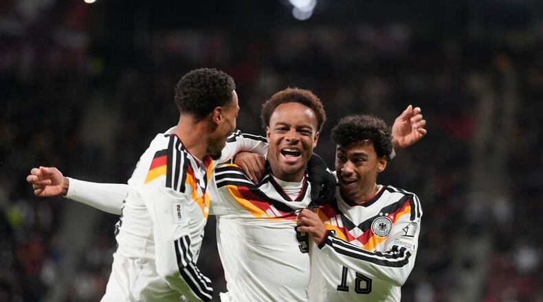 Germany's Assan Ouedraogo, center, celebrates after scoring during a group A World Cup qualifiying soccer match between Germany and Slovakia in Leipzig, Germany, Monday, Nov. 17, 2025. (AP Photo/Matthias Schrader)