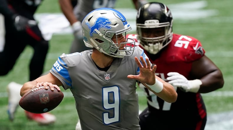 Detroit Lions quarterback Matthew Stafford (9) works in the pocket under pressure by Falcons defensive tackle Grady Jarrett (97) during the first half Sunday, Oct. 25, 2020, at Mercedes-Benz Stadium in Atlanta. (John Bazemore/AP)
