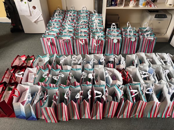 Atlanta native and cancer survivor Sabrina Bridwell prepares gift bags with her son, Jake. Filled with a note and dozens of self-care items, the bags are meant to help fellow cancer patients feel seen and supported. (Courtesy of Sabrina Bridwell)