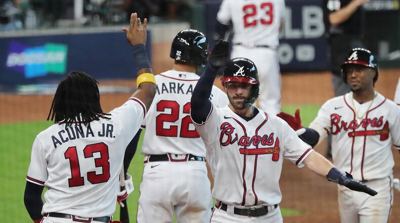 Braves celebrate taking 7-4 lead over Marlins in Game 1 of the National League Division Series Tuesday, Oct. 6, 2020, at Minute Maid Park in Houston. (Curtis Compton / Curtis.Compton@ajc.com)