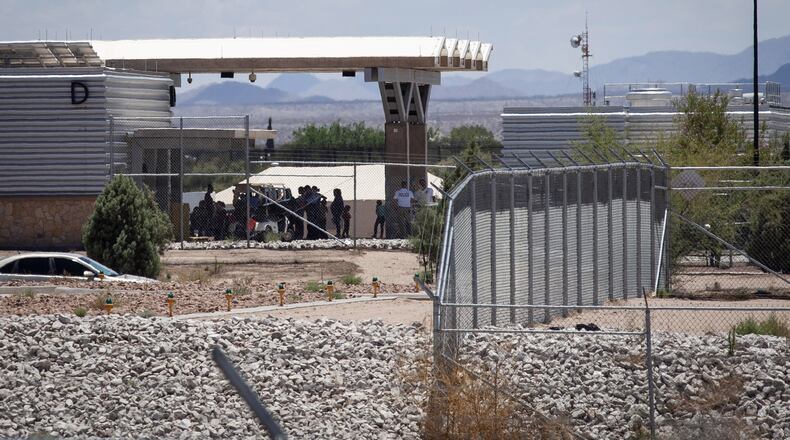 People wait outside the Tornillo-Marcelino Serna Port of Entry, where tents have been built to house unaccompanied migrant children on June 18, 2018 in Tornillo, Texas. (Photo by Christ Chavez/Getty Images)
