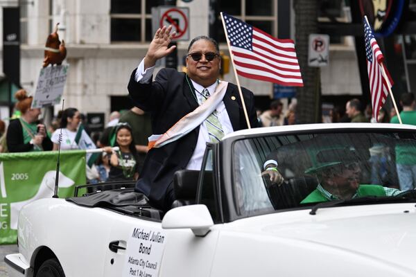 Atlanta Councilman Michael Julian Bond waves as the floats head down Peachtree Street during the Atlanta St. Patrick's Parade, Saturday, March 15, 2025, in Atlanta. (Hyosub Shin / AJC)