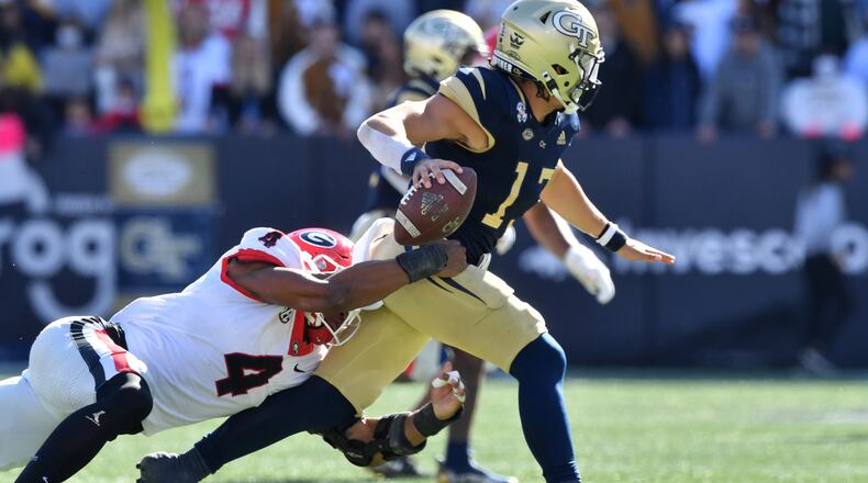 Georgia Tech's quarterback Jordan Yates (13) gets tackled from behind by Georgia's linebacker Nolan Smith (4) during the first half of an NCAA college football game at Georgia Tech's Bobby Dodd Stadium in Atlanta on Saturday, November 27, 2021. Georgia won 45-0 over Georgia Tech. (Hyosub Shin / Hyosub.Shin@ajc.com)