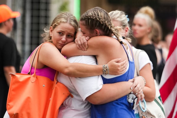Campers embrace after arriving to a reunification area as girls from Camp Waldemar, near the North fork of the Guadalupe River, are reconnected with their families after heavy rainfall in Central Texas, Saturday, July 5, 2025. (Jason Fochtman/Houston Chronicle via AP)