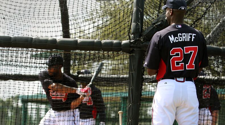 Former Brave Fred McGriff, right, watches as outfielder Jason Heyward bats during spring training in 2012, when McGriff was a guest instructor. Jason Getz jgetz@ajc.com