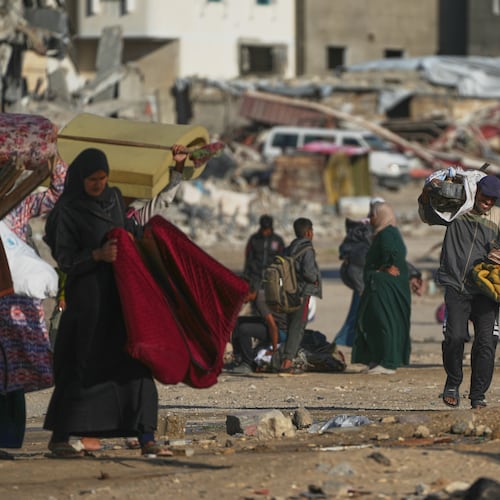 A man Palestinian man carries bags of firewood after collecting them from the rubbish in Khan Younis, southern Gaza Strip, on Saturday, Nov. 15, 2025.(AP Photo/Abdel Kareem Hana)