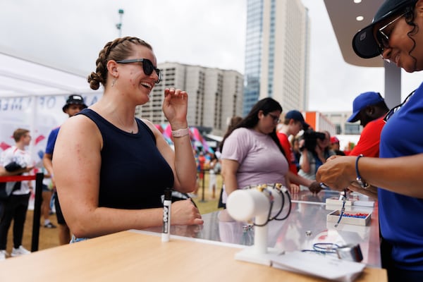 Sadie Dunn makes a custom bracelet at the Bank of America stand in the FIFA Fan Festival in Atlanta, Thursday, June 18, 2026. (Estela Muñoz/AJC)