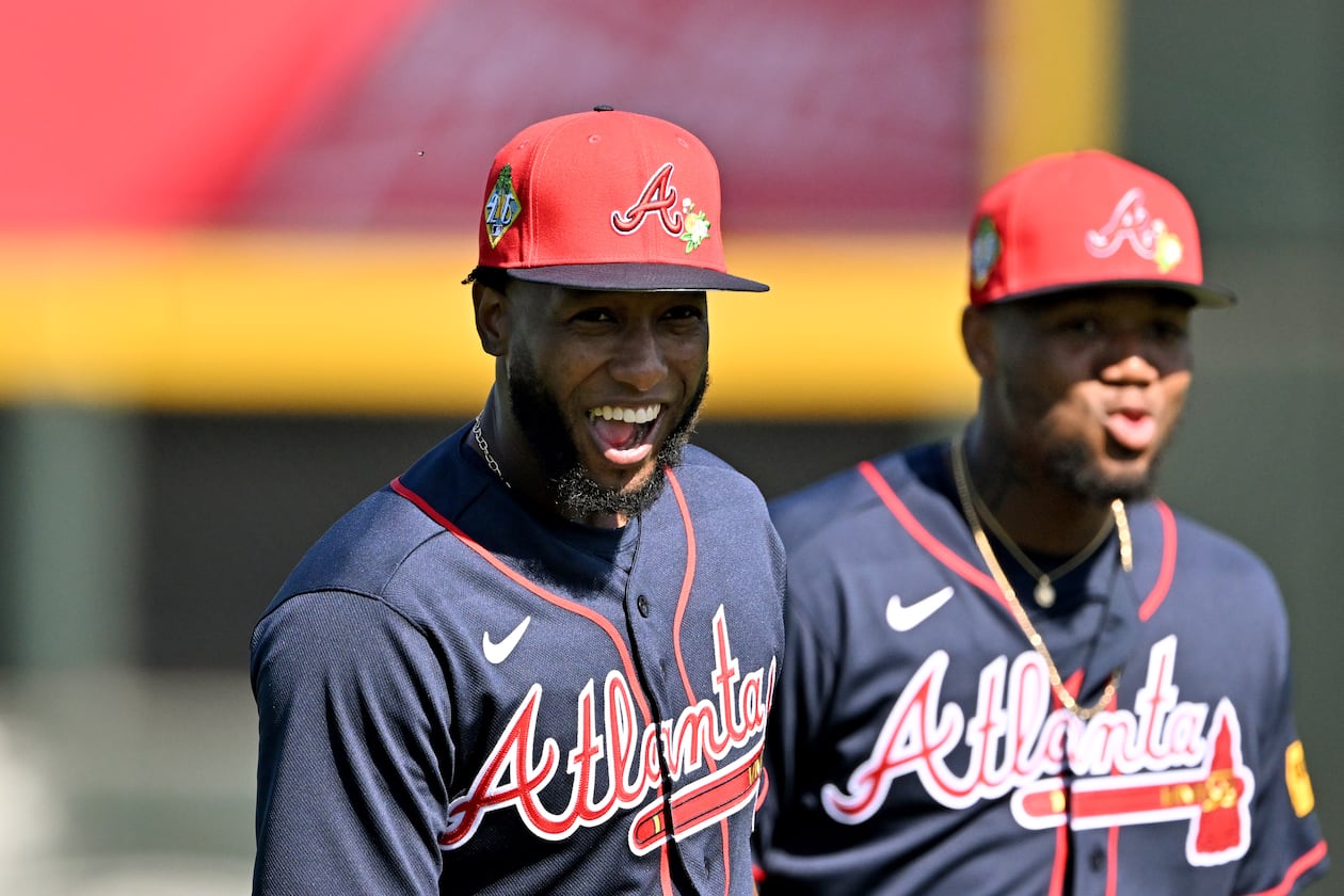 Atlanta Braves outfielder Jurickson Profar (left) and right fielder Ronald Acuña Jr. react as they warm up during the first full-squad spring training workouts at CoolToday Park, Sunday, Feb. 15, 2026, in North Port, Fla. (Hyosub Shin/AJC)