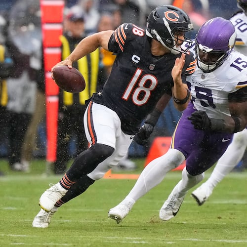 Chicago Bears quarterback Caleb Williams (18) scrambles as Minnesota Vikings outside linebacker Dallas Turner (15) defends during the first half of an NFL football game in Chicago, Sunday, Sept. 20, 2026. (AP Photo/Nam Y. Huh)