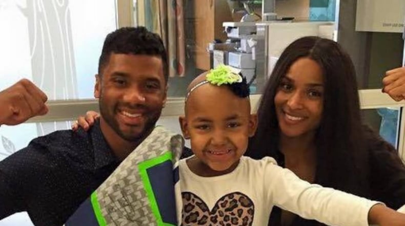 Russell Wilson with his goddaughter, Ailynn. Photograph from Russell's Instagram.