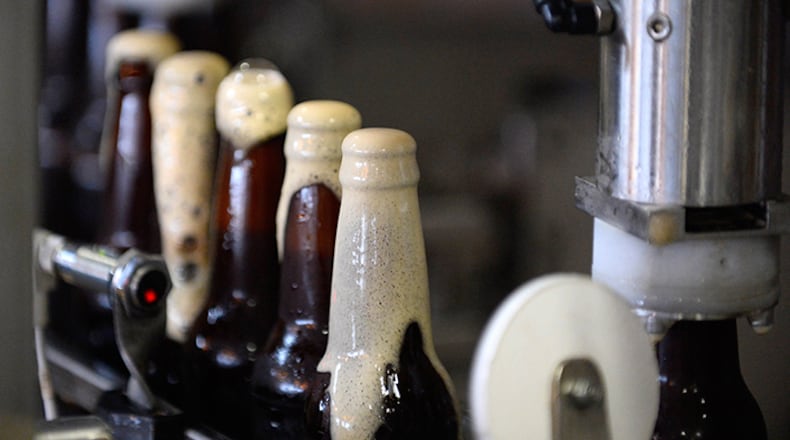 Bottles of Wild Heaven Brewery's Ode to Mercy brown ale are bottled and capped at the Decatur, Ga., brewery.