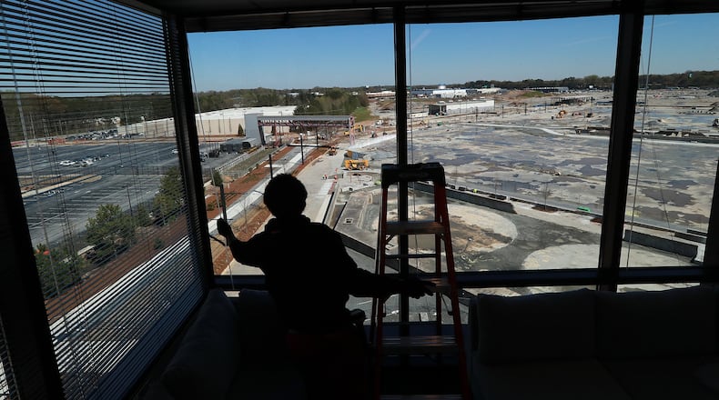 Orien Reid installs window blinds at the new Serta Simons Bedding headquarters overlooking the Assembly development in Doraville.