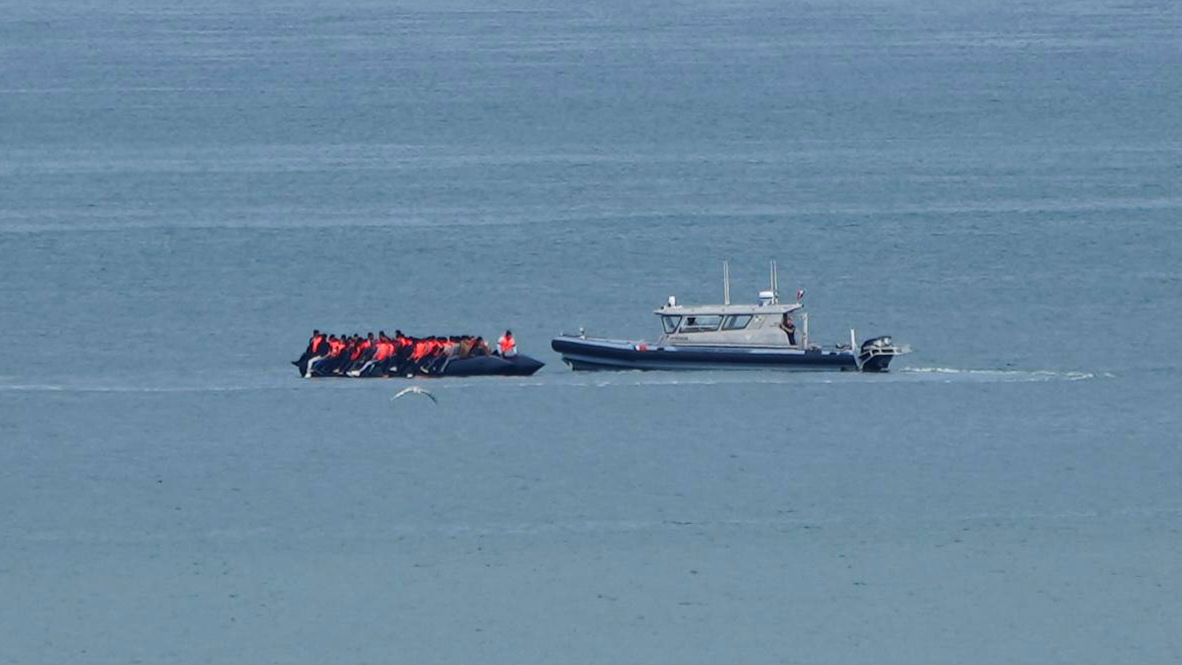 FILE - A boat thought to carry migrants is escorted by a vessel from the French Gendarmerie Nationale in the English Channel off Wimereux beach, France, Wednesday, Sept. 4, 2024. (AP Photo/Nicolas Garriga, File)