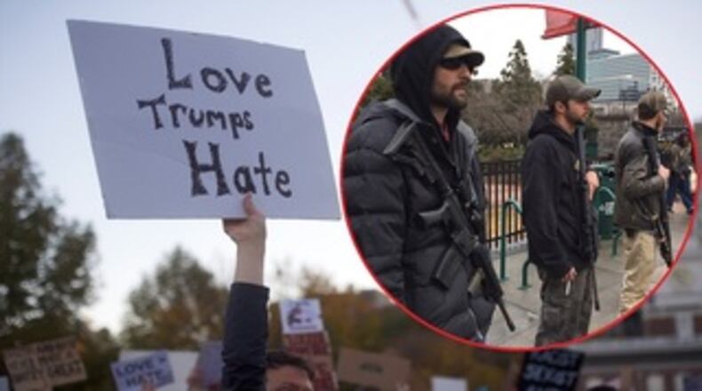 A few members of a militia group called the III% Security Force held signs and openly carried handguns and a few military-type rifles and shotguns on Saturday, saying they were there to keep the peace and protect their Second Amendment right to bear arms. (Credit: Channel 2 Action News)