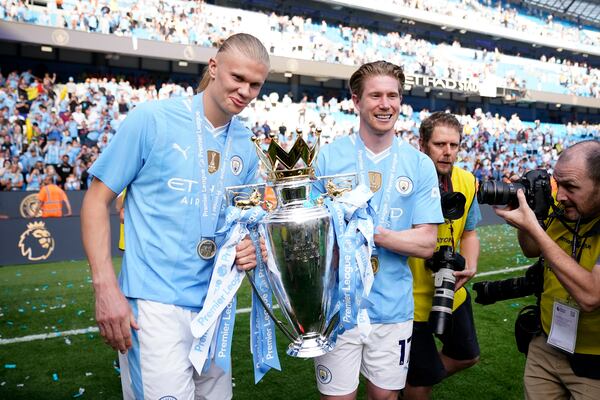 FILE - Manchester City's Erling Haaland, left, and Manchester City's Kevin De Bruyne celebrate with the Premier League trophy after the English Premier League soccer match between Manchester City and West Ham United at the Etihad Stadium in Manchester, England, Sunday, May 19, 2024. (AP Photo/Dave Thompson, file)