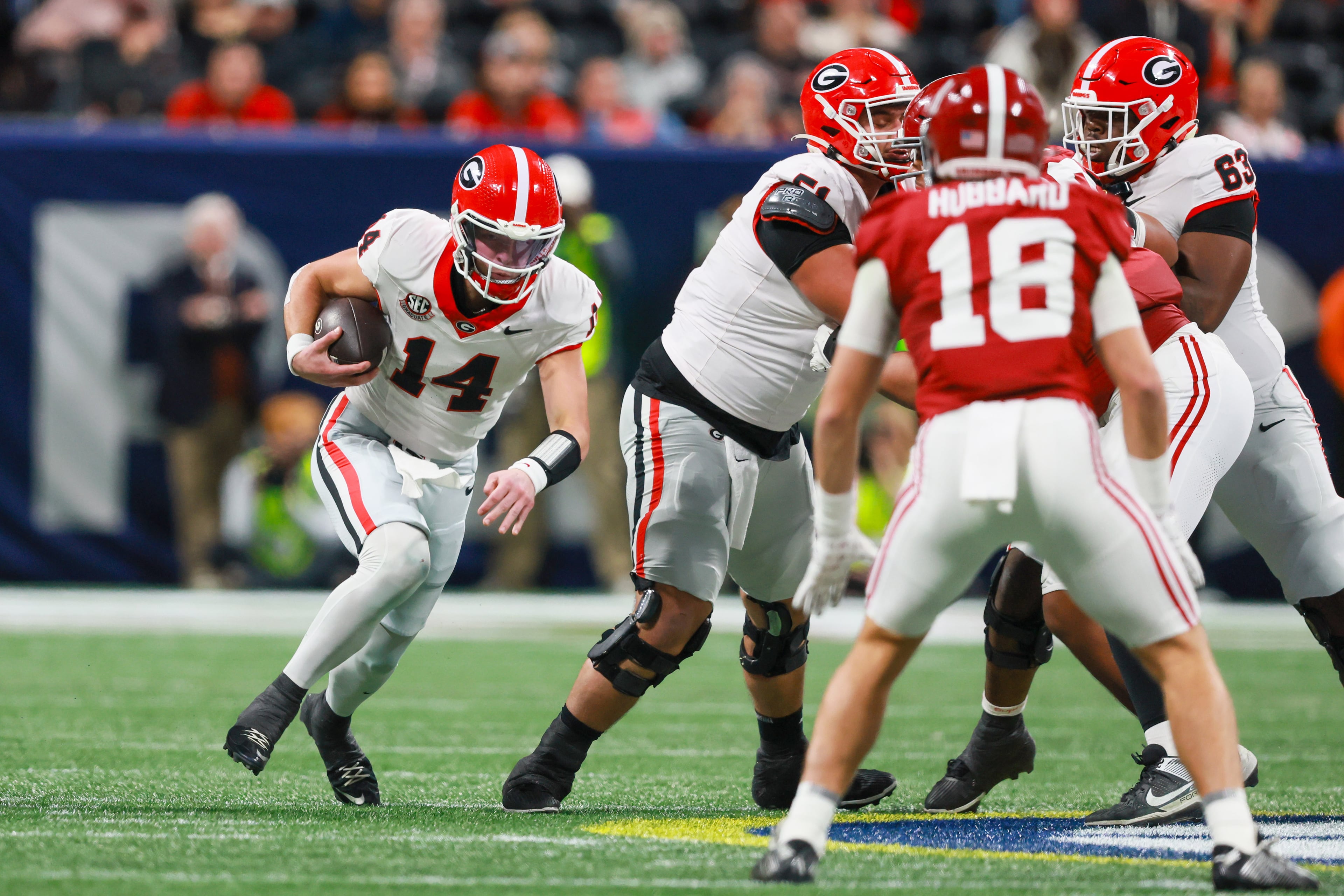 Georgia quarterback Gunner Stockton (14) runs the ball against the Alabama defense including defensive back Bray Hubbard (18) during the first half of the SEC Championship game at Mercedes-Benz Stadium, Saturday, Dec. 6, 2025, in Atlanta. (Jason Getz / AJC)