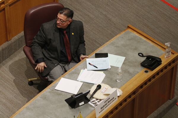 Republican state Sen. Gabriel Ramos of Silver City, N.M., rests the microphone on a stack of locally made tortillas amid debate on a bill to designate tortillas as the official state bread in Santa Fe, N.M., on Tuesday, March 18, 2025. (AP Photo/Morgan Lee)