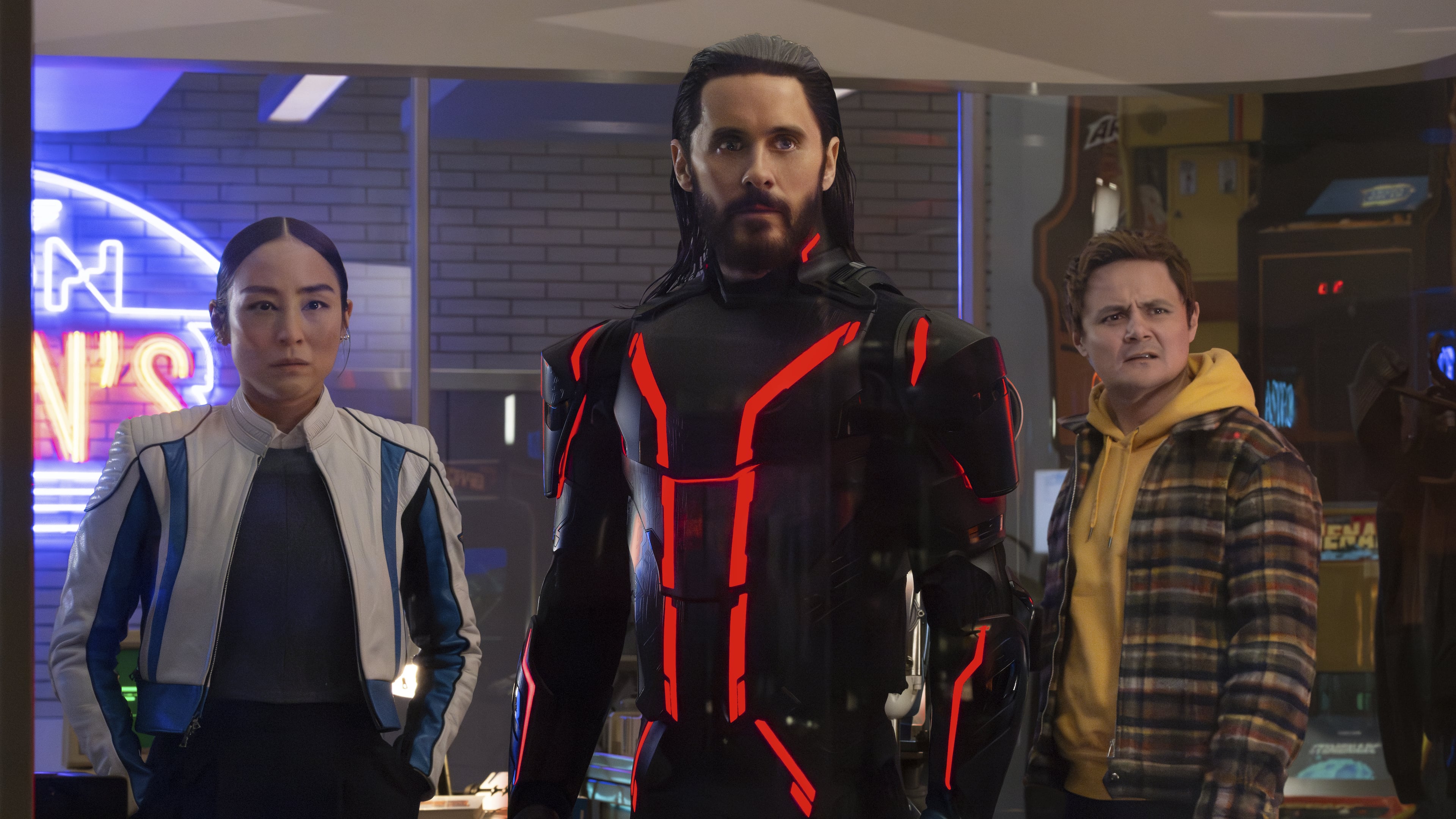This image released by Disney shows Greta Lee, from left, Jared Leto and Arturo Castro in a scene from "Tron: Ares." (Disney via AP)