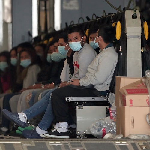 FILE - Migrants wearing face masks and shackles on their hands and feet sit on a military aircraft at Fort Bliss in El Paso, Texas, Jan. 30, 2025, awaiting their deportation to Guatemala. (AP Photo/Christian Chavez, File)
