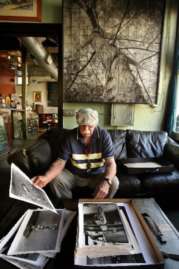 Catledge leafed through his Cabbagetown prints in this 2006 photo. CONTRIBUTED BY JOEY IVANSCO