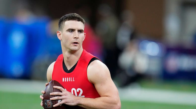 Georgia quarterback Stetson Bennett warms up before he runs a drill at the NFL football scouting combine in Indianapolis, Saturday, March 4, 2023. (AP Photo/Michael Conroy)