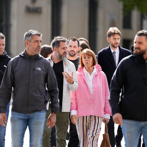 Gisele Pelicot and her son Florian Pelicot, third left, return to the courthouse during the appeals trial in the case of a man challenging his conviction, less than a year after the landmark verdict in a drugging and rape trial that shook France Thursday, Oct. 9, 2025 in Nimes, southern France. (AP Photo/Lewis Joly)