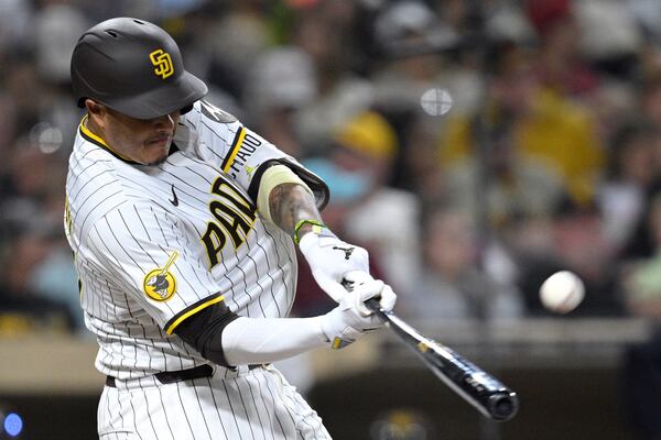 San Diego Padres' Manny Machado hits a home run against the Arizona Diamondbacks during the eighth inning of a baseball game against the Arizona Diamondbacks Monday, July 7, 2025, in San Diego. (AP Photo/Orlando Ramirez)