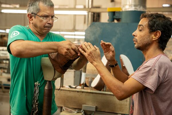 Workers at a factory in Franca, Brazil, manufacture shoes for Michael Ellis Footwear, the brand from LaGrange-based 2BigFeet. (Courtesy of 2BigFeet)