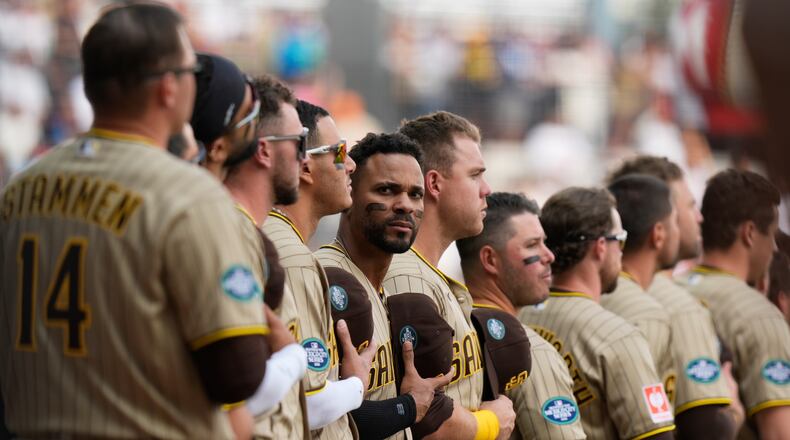 San Diego Padres' Xander Bogaerts, center, and teammate stand line prior to a baseball game against Arizona Diamondbacks in Mexico City, Saturday, April 25, 2026. (AP Photo/Fernando Llano)