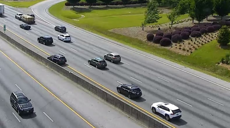 Drivers stopped in traffic to get a stray dog from the left shoulder on I-20 westbound at Riverside Pkwy (Exit 46) on Monday, June 12, 2023. WSB TRAFFIC