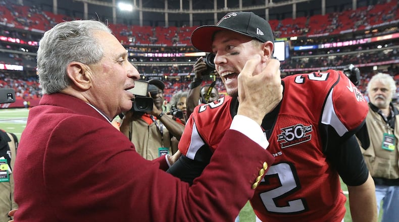 Falcons owner Arthur Blank and quarterback Matt Ryan celebrate ending Carolina's perfect season with a 20-13 victory at the Georgia Dome. (Curtis Compton/ccompton@ajc.com)