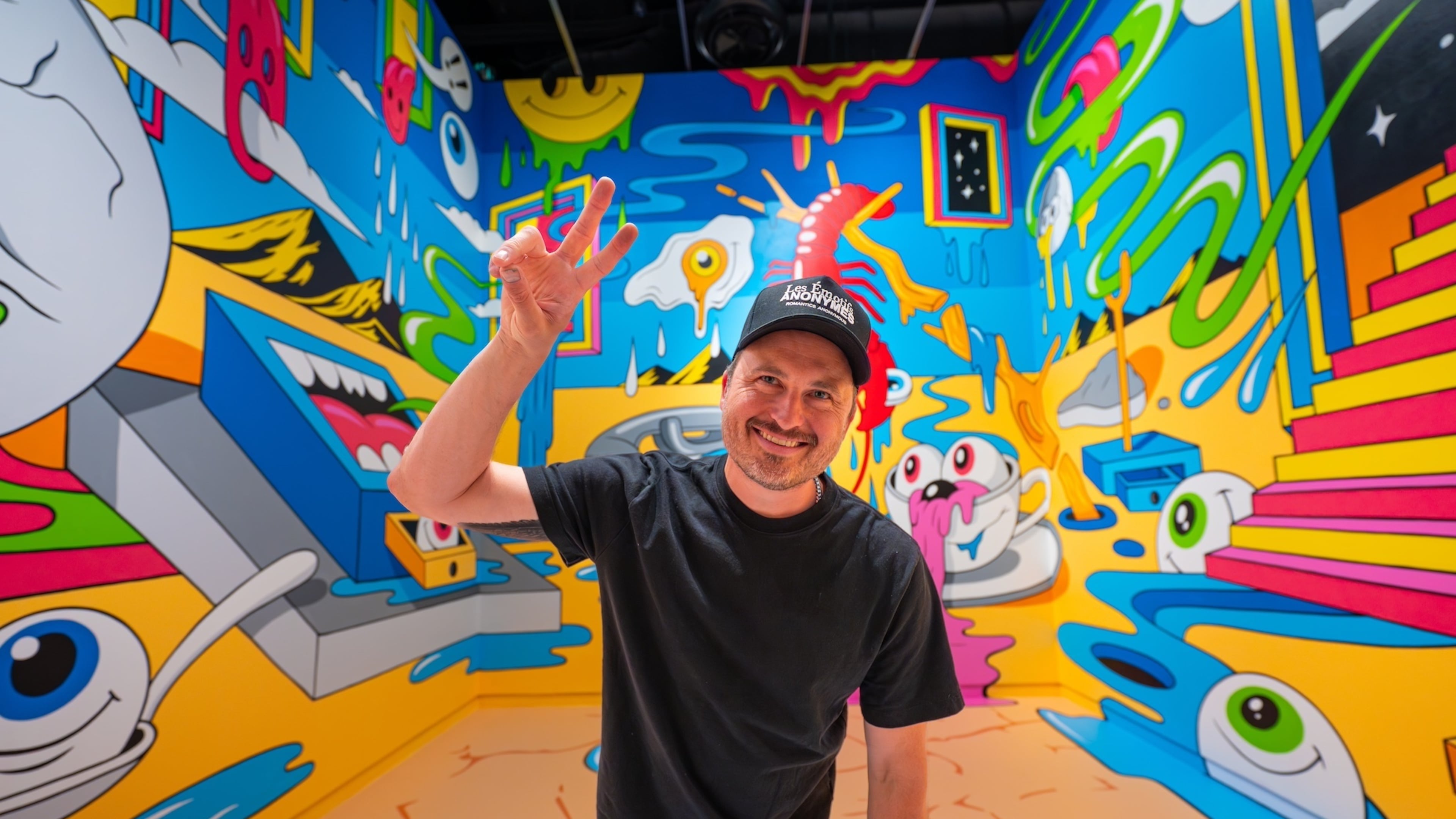 Atlanta artist Greg Mike with his mural inspired by the Spanish artist Salvador Dalí on view through Oct. 26 at The Dalí Museum in St. Petersburg, Florida. (Courtesy of Greg Mike)