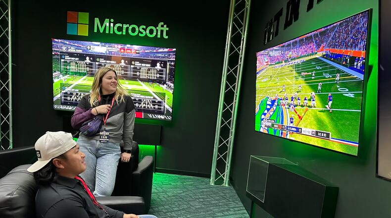 El Paso, Texas, resident Michael Vo visits the College Football Hall of Fame on Dec. 13, 2023 while in Atlanta with his girlfriend Rebecca Thompson, who is from Georgia. RODNEY HO/rho@ajc.com
