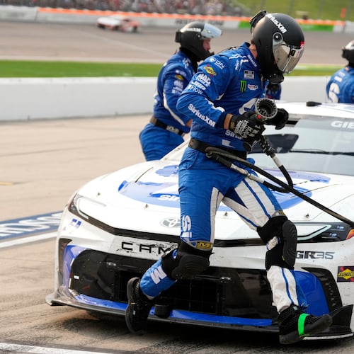 A crew member leaps in front of Ty Gibbs' car during a pit stop in a NASCAR Cup Series auto race, Sunday, Aug. 9, 2026, at Iowa Speedway in Newton, Iowa. (AP Photo/Charlie Neibergall)
