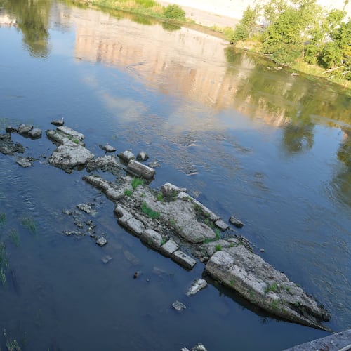 The ruins of the ancient Roman Neronian bridge, emerge from the riverbed of the Tiber river due to drought, in Rome, Thursday, Aug. 13, 2026. (AP Photo/Gregorio Borgia)
