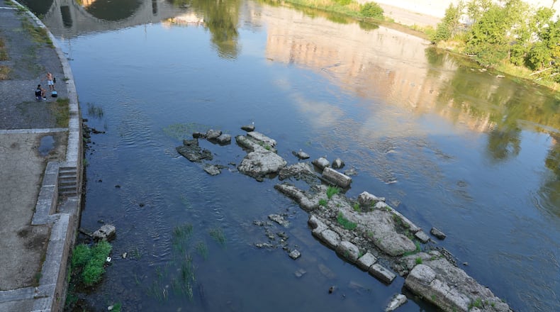 The ruins of the ancient Roman Neronian bridge, emerge from the riverbed of the Tiber river due to drought, in Rome, Thursday, Aug. 13, 2026. (AP Photo/Gregorio Borgia)
