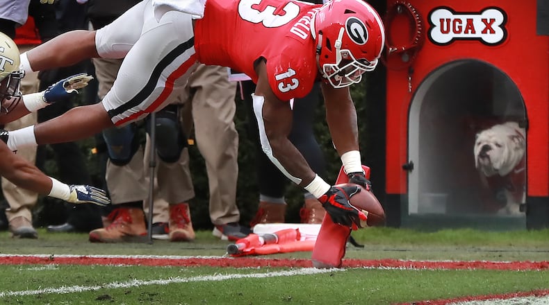 UGA X looks on as tailback Elijah Holyfield dives into the end zone for a touchdown and a 35-7 lead over Georgia Tech.